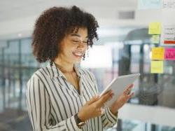 Black female entrepreneur looking at tablet